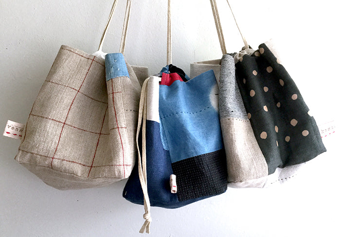 3 Modern Japanese Rice Pouches with the colors beige, blue/black, and beige/black from left to right